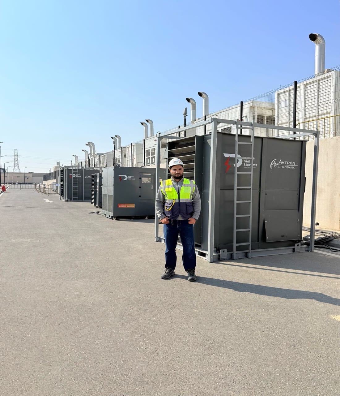 PLS engineer in front of containerised load banks at the Sahayeb data centres, Dammam